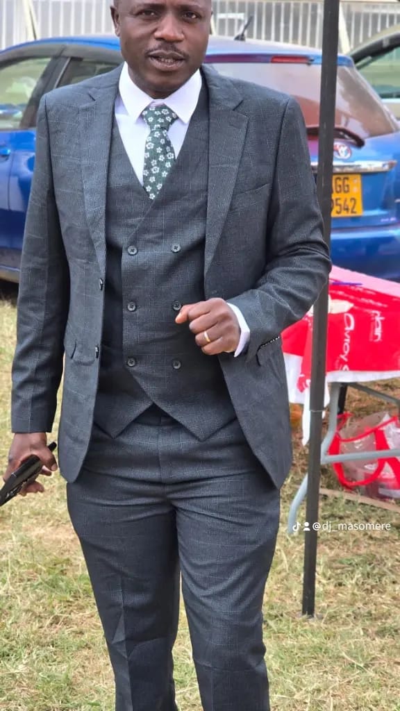 DJ Masomere in charcoal three-piece suit